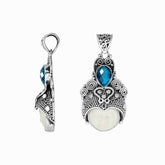 Balinese bone face pendant with blue topaz quartz in sterling silver, handcrafted jewelry.